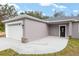New home with gray exterior, white garage door, and black front door at 39926 Parkinsonia St, Lady Lake, FL 32159