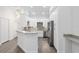 Modern kitchen with white cabinets, breakfast bar, and grey floor at 39926 Parkinsonia St, Lady Lake, FL 32159