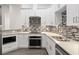 Modern kitchen with white cabinets, stainless steel appliances, and mosaic backsplash at 39926 Parkinsonia St, Lady Lake, FL 32159