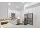 Bright kitchen featuring white cabinets, stainless steel appliances, and mosaic tile at 39926 Parkinsonia St, Lady Lake, FL 32159