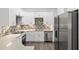 Modern kitchen with white cabinets, stainless steel appliances, and mosaic backsplash at 39926 Parkinsonia St, Lady Lake, FL 32159