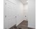 Bright laundry room with white walls, wood flooring, and built-in shelving at 39926 Parkinsonia St, Lady Lake, FL 32159
