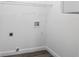 Clean laundry room with white walls, wood flooring, and a hook for hanging clothes at 39926 Parkinsonia St, Lady Lake, FL 32159