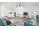 Living room with kitchen view, stylish furniture, and a large TV at 39926 Parkinsonia St, Lady Lake, FL 32159