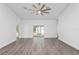 Bright living room with grey flooring, ceiling fan, and sliding glass doors at 39926 Parkinsonia St, Lady Lake, FL 32159
