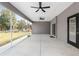 Large screened lanai with ceiling fans and backyard access at 39926 Parkinsonia St, Lady Lake, FL 32159