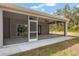 Spacious screened porch with ceiling fans and sliding glass doors at 39926 Parkinsonia St, Lady Lake, FL 32159