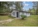 Charming single-story home with a black door and landscaping at 5238 Nw 61St Ln, Ocala, FL 34482