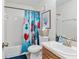 Bathroom with tub, toilet, and snowman shower curtain at 56 Pine Trak # 101E, Ocala, FL 34472