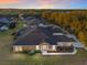 Twilight aerial view showcasing the home, landscaping, and community at 7102 Sw 91St Ct, Ocala, FL 34481