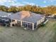 View of the backyard from above showcasing the screened lanai and lush grass at 7102 Sw 91St Ct, Ocala, FL 34481