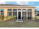 Exterior view of the home's backyard, showcasing the enclosed patio at 7102 Sw 91St Ct, Ocala, FL 34481