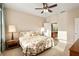 Inviting bedroom with ceiling fan, carpeted floor, and ensuite bathroom access at 7102 Sw 91St Ct, Ocala, FL 34481