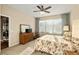 Spacious bedroom with ceiling fan, large window, carpeted floor, and sliding glass door at 7102 Sw 91St Ct, Ocala, FL 34481