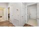 Hallway with doors leading to bathroom, bedroom, and laundry room at 7102 Sw 91St Ct, Ocala, FL 34481