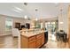 Open-concept kitchen and living area with breakfast bar and view of patio at 7102 Sw 91St Ct, Ocala, FL 34481