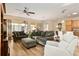 Inviting living room featuring plush seating, wood floors, and a ceiling fan at 7102 Sw 91St Ct, Ocala, FL 34481