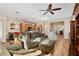 Comfortable living space with soft seating, warm wood floors, and ample natural light at 7102 Sw 91St Ct, Ocala, FL 34481