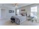 Main bedroom with a plush bed, stylish decor, and windows at 8473 Las Palmas Way, Wildwood, FL 34785