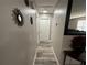 Hallway with wood-look flooring leading to various rooms at 8788 Se 88Th Pl, Ocala, FL 34472