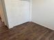 Bedroom with wood-look floors and double door closet at 10913 Sw 69Th Cir, Ocala, FL 34476