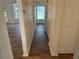 Hallway with wood-look floors and access to bedrooms at 10913 Sw 69Th Cir, Ocala, FL 34476