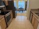 Kitchen with stainless steel appliances and view of dining area at 10913 Sw 69Th Cir, Ocala, FL 34476