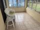 Relaxing sunroom featuring wicker furniture and pool view at 10913 Sw 69Th Cir, Ocala, FL 34476