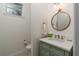 Small bathroom with pedestal sink, toilet and mirror at 15620 Nw 112Th Ave, Reddick, FL 32686