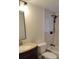 Bathroom with dark vanity, tub, and updated shower at 1570 Se 27Th St # H, Ocala, FL 34471