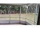 Screened porch overlooking a grassy backyard with trees at 1570 Se 27Th St # H, Ocala, FL 34471