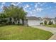 House exterior showcasing a two-car garage and lush landscaping at 2505 Se 18Th Cir, Ocala, FL 34471