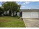 Two-car garage and front entry of a charming villa at 2505 Se 18Th Cir, Ocala, FL 34471