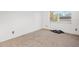 Simple bedroom with neutral carpeting and a large window at 2837 Ne 3Rd St # 103, Ocala, FL 34470