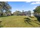 Spacious backyard with large grassy area and screened pool at 5002 Se 7Th Pl, Ocala, FL 34471