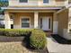 House entrance with covered porch and lush landscaping at 5097 Sw 40Th Pl, Ocala, FL 34474