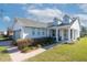 Gray house with gray roof, white columns, and landscaped yard at 5098 Nw 35Th Lane Rd, Ocala, FL 34482