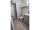 Bathroom features a walk-in shower and gray tile at 548 Fairways Dr # B, Ocala, FL 34472