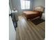 Bright bedroom with a queen bed and wood-look flooring at 548 Fairways Dr # B, Ocala, FL 34472