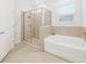 Bathroom boasts a shower and a soaking tub at 6243 Sw 89Th Street Rd, Ocala, FL 34476