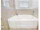 White soaking tub with neutral tile surround at 6243 Sw 89Th Street Rd, Ocala, FL 34476