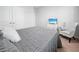 Spacious bedroom featuring a gray comforter and a relaxing armchair at 6243 Sw 89Th Street Rd, Ocala, FL 34476