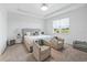 Bright bedroom with a king-size bed and two armchairs at 6243 Sw 89Th Street Rd, Ocala, FL 34476