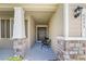 Front porch entryway with stone pillars and a sitting area at 6243 Sw 89Th Street Rd, Ocala, FL 34476
