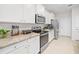 Kitchen boasts granite counters and white cabinets at 6243 Sw 89Th Street Rd, Ocala, FL 34476