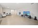 Bright living room features tile floors and a large TV at 6243 Sw 89Th Street Rd, Ocala, FL 34476