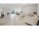 Open living room with tile floors, sofa, and view into kitchen at 6243 Sw 89Th Street Rd, Ocala, FL 34476