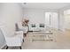 Living area with light-colored sofas and a glass coffee table at 6243 Sw 89Th Street Rd, Ocala, FL 34476