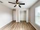 Bedroom with ceiling fan, closet, window, and wood-look flooring at 6300 Sw 144Th Lane Rd, Ocala, FL 34473