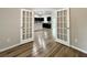 Hallway with wood-look floors and French doors leading to another room at 6300 Sw 144Th Lane Rd, Ocala, FL 34473